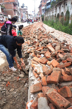 A DTS team clears debris from a roadway in Kathmandu