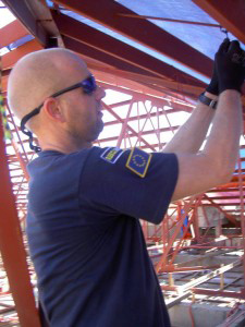 RescueNet worker repairs town hall roof